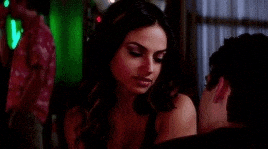 a man and a woman are sitting next to each other in a room .