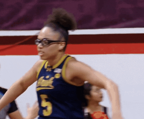 a female basketball player wearing glasses and a jersey with the number 5 on it