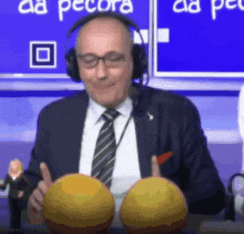 a man wearing headphones holds two yellow balls