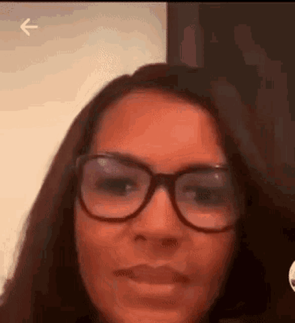 a woman wearing glasses is making a funny face .