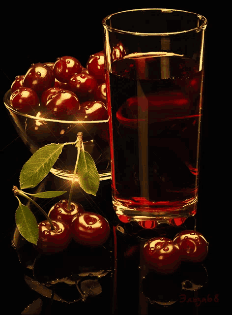 a glass of cherries next to a bowl of cherries