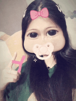 a girl with a pacifier in her mouth and a pink bow on her head
