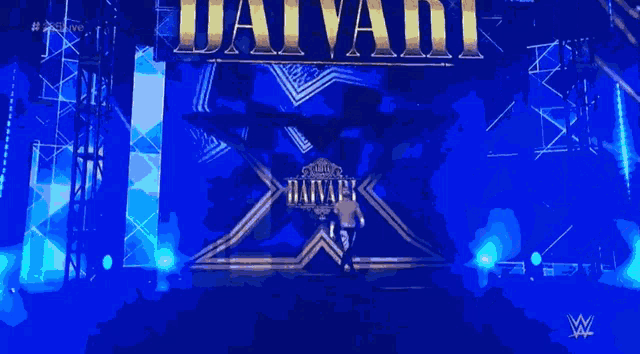 a man is standing in front of a sign that says daivark on it