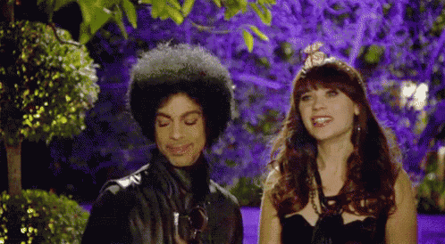 prince and a woman are standing next to each other in a garden .