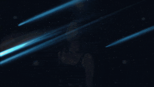 a woman in a black tank top is standing in front of a starry sky