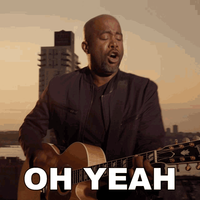 a man singing and playing a guitar with the words oh yeah below him