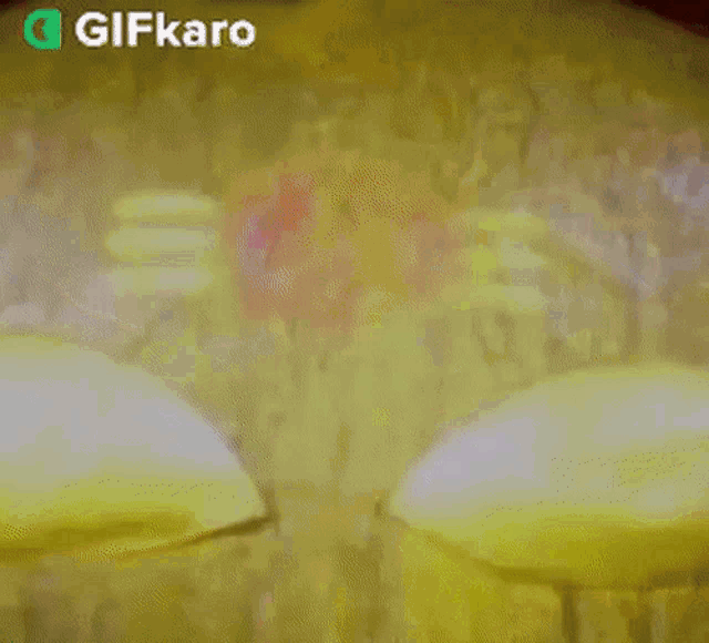 a blurry picture of a red light with the words gifkaro on the bottom right