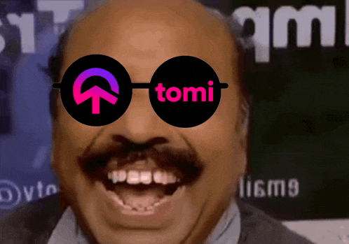 a bald man with a mustache wearing sunglasses with the word tomi on them