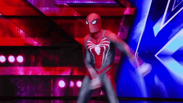 a person in a spiderman costume is dancing on a stage