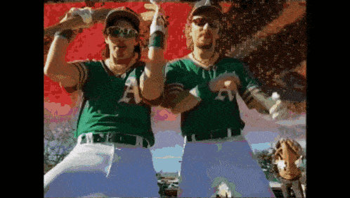 a couple of baseball players with a on their jerseys