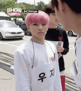 a boy with pink hair is wearing a white shirt that says show champion on it