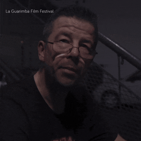 a man wearing glasses and a shirt that says ' la guarimba film festival '