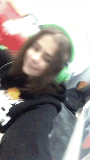 a blurry photo of a girl wearing headphones