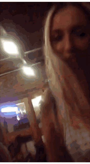 a blurry photo of a woman with blonde hair