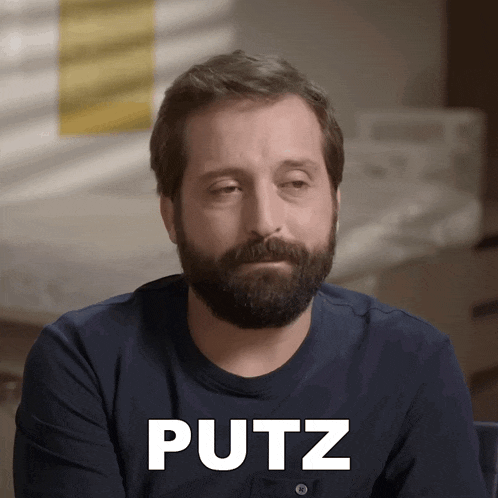 a man with a beard has the word putz written on his face