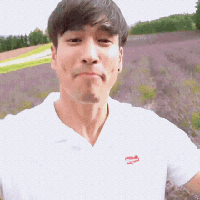 a man wearing a white shirt with a red heart on the front