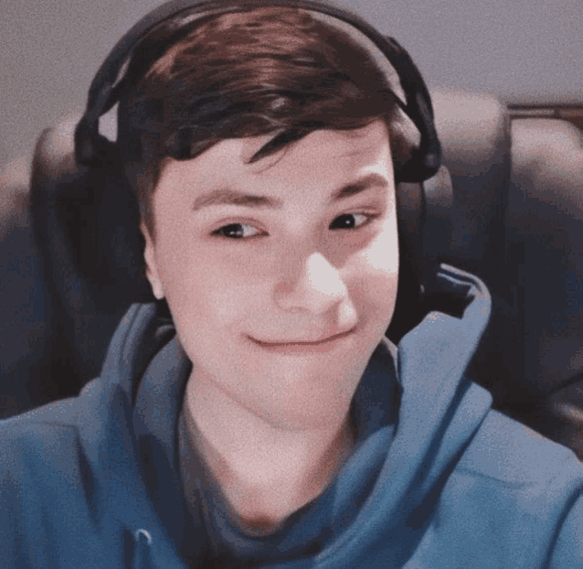 a young man wearing headphones and a blue shirt