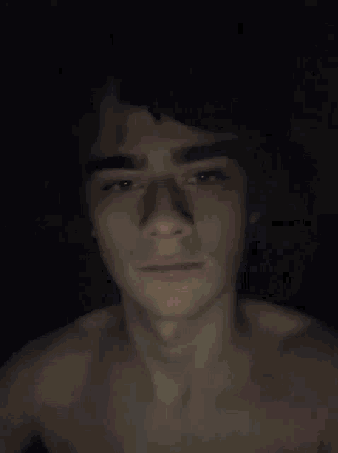 a blurry image of a person 's face in the dark .