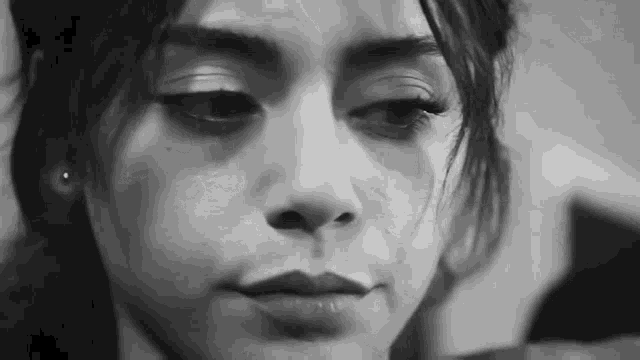 a black and white photo of a woman 's face .