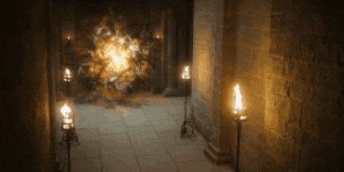 a dimly lit hallway with candles and a glowing object in the background