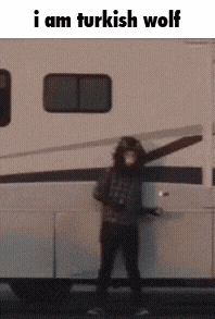 a person standing in front of a trailer with the words i am turkish wolf