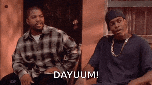 two men are sitting next to each other in a chair and one of them is saying dayuum .