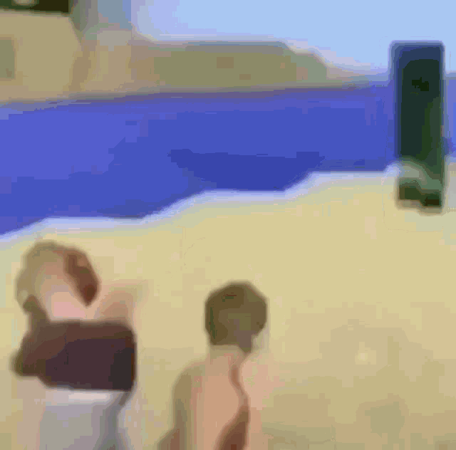 a blurry picture of two people standing on a beach near a pool .