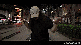 a man is dancing on the sidewalk in front of a cvs store