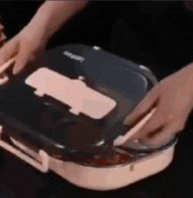 a person is opening a lunch box with a fork and knife .