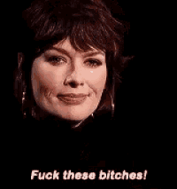 a close up of a woman 's face with the words `` fuck these bitches ! ''