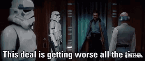 a group of stormtroopers are standing next to each other in a room and talking to a man .