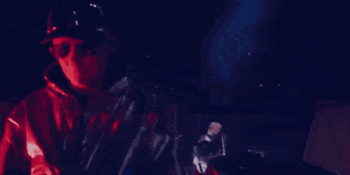 a man is playing a keyboard on a stage in front of a crowd