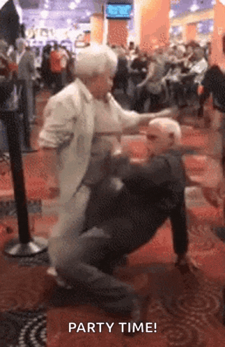 an elderly couple dancing in a crowded room with the words party time written below them