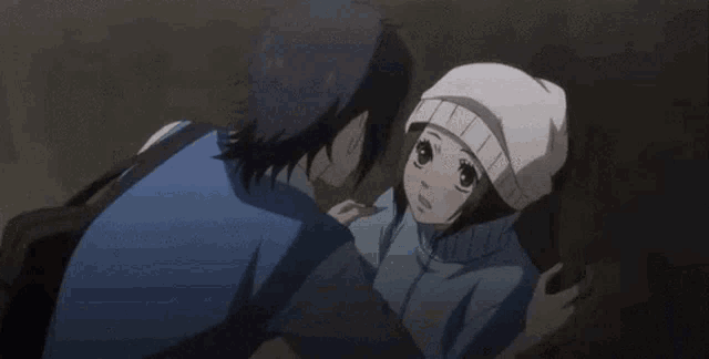 a man and a woman are kissing in a close up of an anime scene .