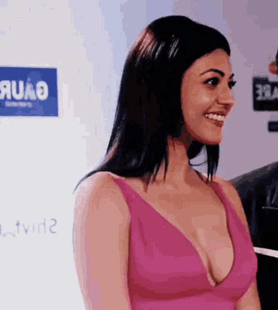 a woman in a pink dress with a plunging neckline