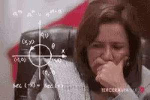 a woman is sitting in front of a chalkboard with a mathematical problem .