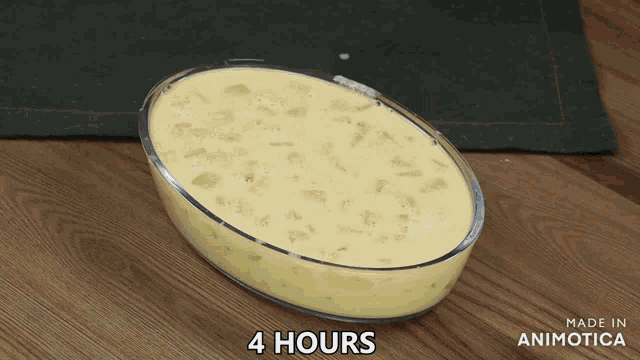 a casserole dish filled with a yellow liquid that says 4 hours made in animotica