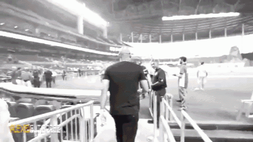 a black and white photo of a man in a stadium