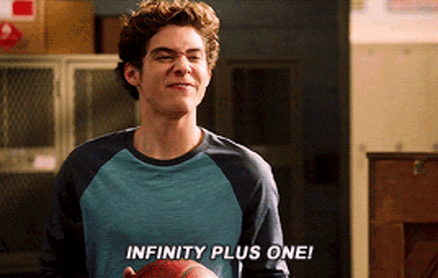 a young man holding a basketball with the words infinity plus one written on his shirt
