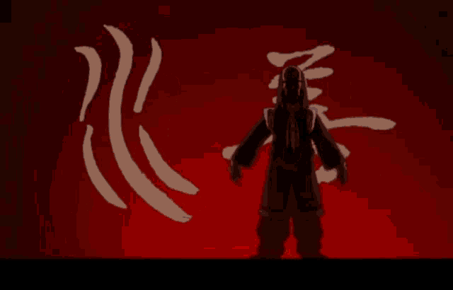 a man is standing in front of a red background with chinese writing on it