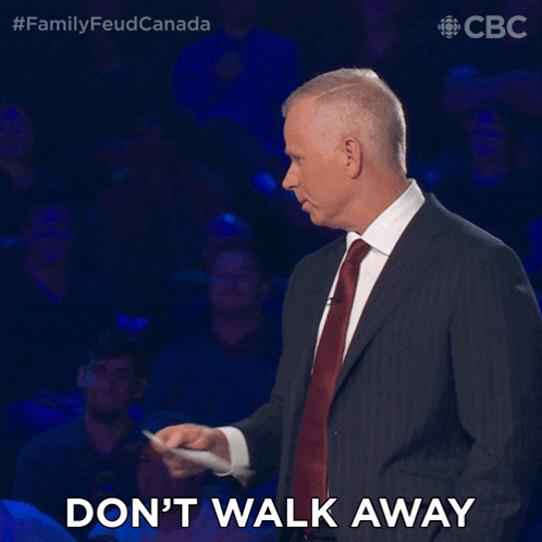 a man in a suit and tie is holding a piece of paper and says " don 't walk away "