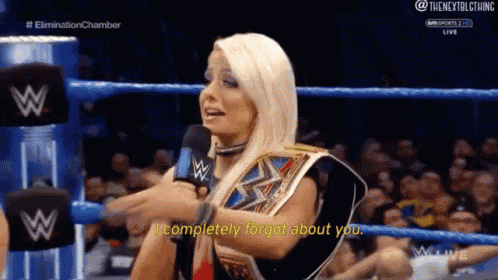 a woman in a wrestling ring talking into a microphone and saying i completely forgot about you