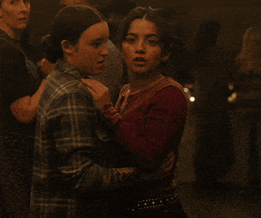 two women are standing next to each other and smiling