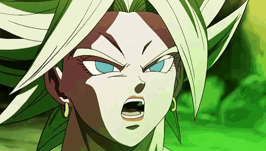 a close up of a dragon ball z character with green hair and blue eyes making a funny face .