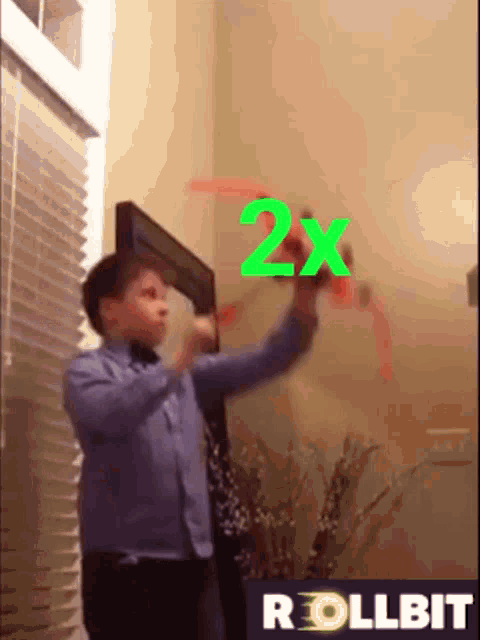 a young boy is playing with a toy that says 2x