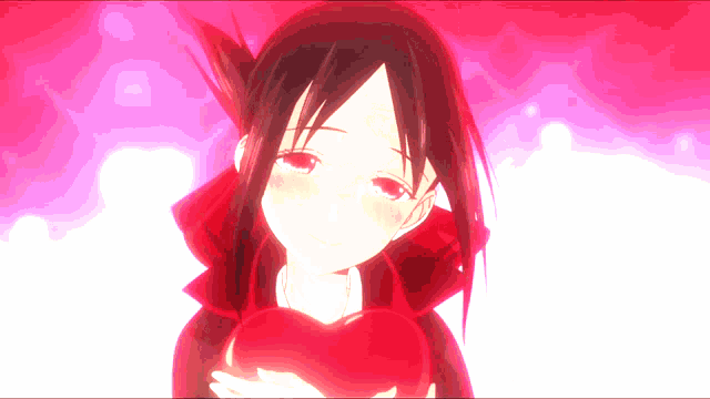 a girl in a red dress is holding a red heart in her hands