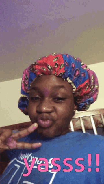 a girl wearing a colorful bonnet says yasss !!