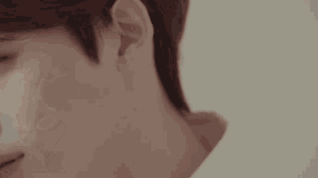 a close up of a young man 's face with a white background .