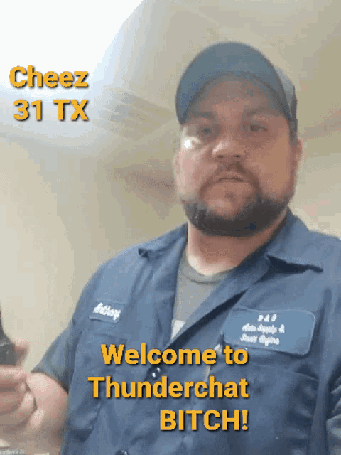 a man wearing a blue shirt that says welcome to thunderchat bitch on it
