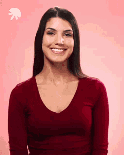a woman in a red shirt is smiling with an arrow pointing up